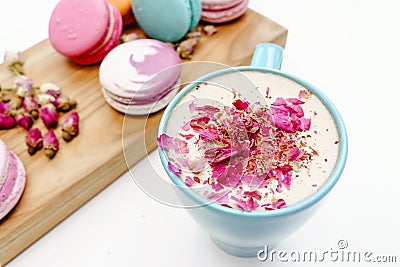 French beautiful macarons on wood desk and blue cup of aroma cappuccino Stock Photo