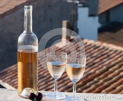 French cold rose dry wine from Provence s in sunny day with view on old roofs of Arles town in sunny day Stock Photo