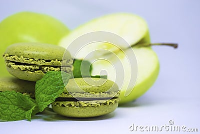 French macaroons and green apple, white background Stock Photo