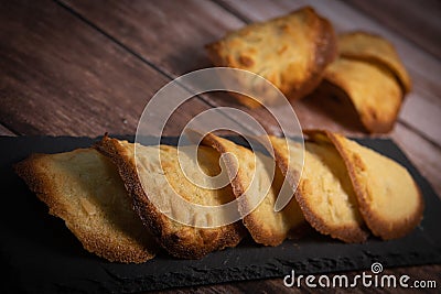 French delicacy pastry tuile with almond on wood background Stock Photo