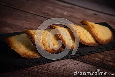 French delicacy pastry tuile with almond on wood background Stock Photo