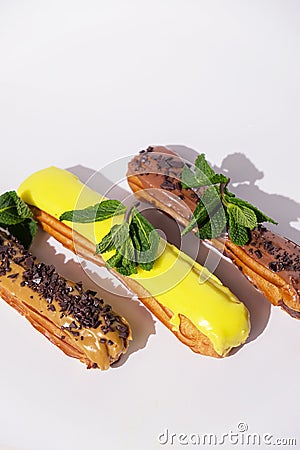 French eclairs with choclate top and different fillings. Traditional recipe, French cuisine. Stock Photo