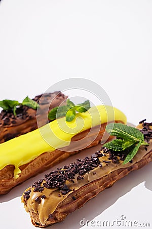 French eclairs with choclate top and different fillings. Traditional recipe, French cuisine. Stock Photo