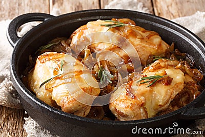 French food chicken onion fillet with cheese and spicy wine sauce close-up in a pan on the table. horizontal Stock Photo