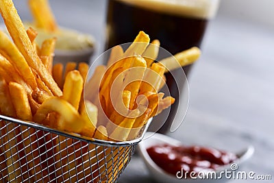 French fries in a metal basket and a soda Stock Photo