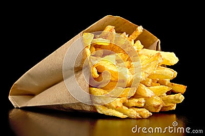 French fries in the paper bag isolated on black Stock Photo