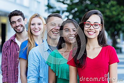 French girl with male and female young adults in line Stock Photo