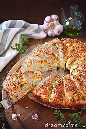 French homemade sourdough white bread with garlic, grated cheese, olive oil and parsley Stock Photo