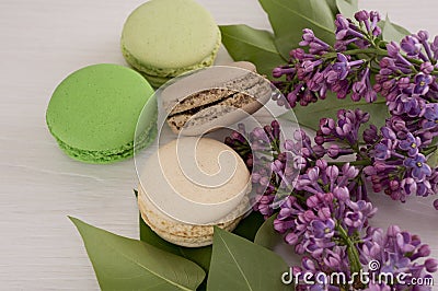 French macarons with twigs of lilacs. Close-up Stock Photo