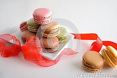 French macaroons gift presentation with red bow on white table Stock Photo