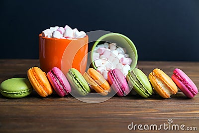 French macaroons and marshmellow in dark wooden background Stock Photo