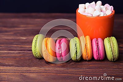 French macaroons and marshmellow in dark wooden background Stock Photo