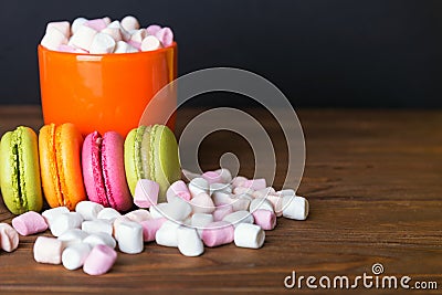 French macaroons and marshmellow in dark wooden background Stock Photo