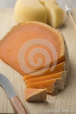 French Mimolette cheese on a cutting board Stock Photo