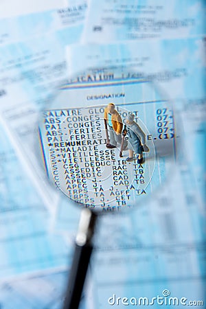 French payroll seen in detail through a magnifying glass showing social security contributions for retirement and sickness Stock Photo