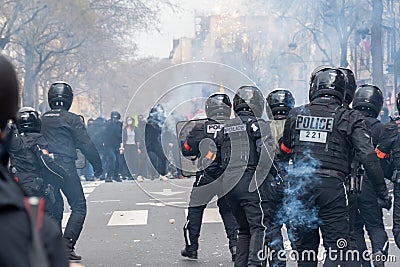 French riot police (Brav) facing rioters in the smoke of tear gas, Paris, France Editorial Stock Photo