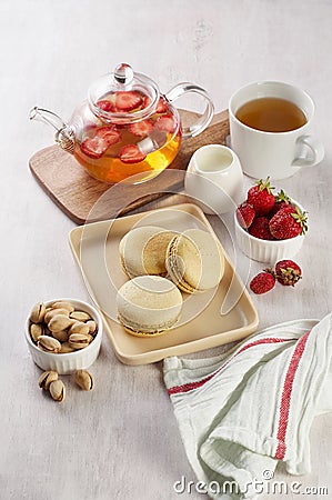 French strawberry pistachio macaron with berries tea. Afternoon tea still life Stock Photo