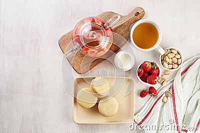 French strawberry pistachio macaron with berries tea. Afternoon tea still life Stock Photo