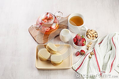 French strawberry pistachio macaron with berries tea. Afternoon tea still life Stock Photo