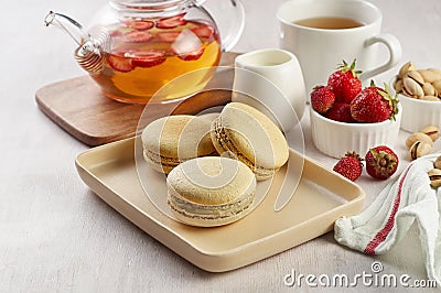 French strawberry pistachio macaron with berries tea. Afternoon tea still life Stock Photo