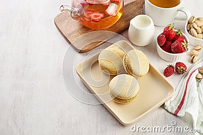 French strawberry pistachio macaron with berries tea. Afternoon tea still life Stock Photo