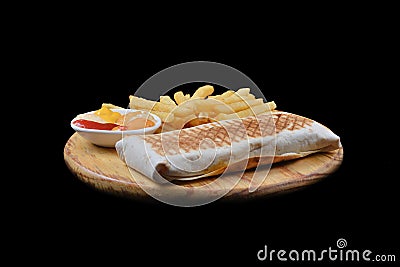 French tacos with chicken. Served with french fries, mayonnaise, ketchup and mustard on a black background Stock Photo