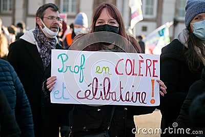 French teacher protesting with placard in french : prof en colere et celibataire, in english : angry teacher and single Editorial Stock Photo