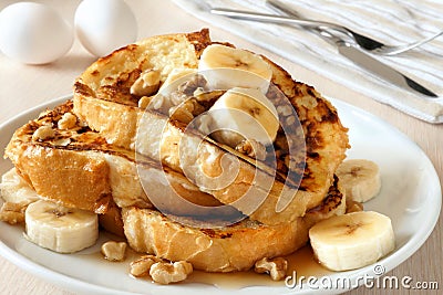 French toast with bananas, walnuts and maple syrup Stock Photo