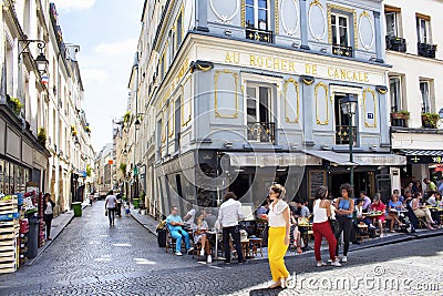 French woman passes by a cafe/bistro Editorial Stock Photo