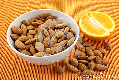 Fresh almonds and orange Stock Photo
