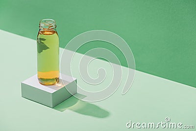 Fresh apple juice on white cube on green and turquoise background Stock Photo