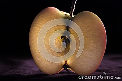 Fresh apple slice cut backlit isolated on black background close-up. Design element Stock Photo