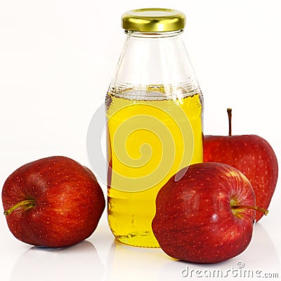 Fresh apples and a bottle of apple cider vinegar. Stock Photo