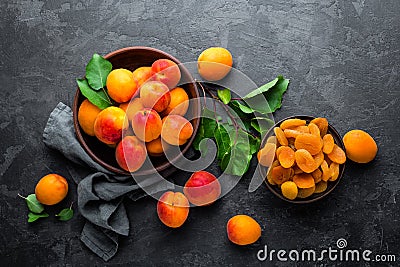 Fresh apricots with leaves and dried in bowl Stock Photo