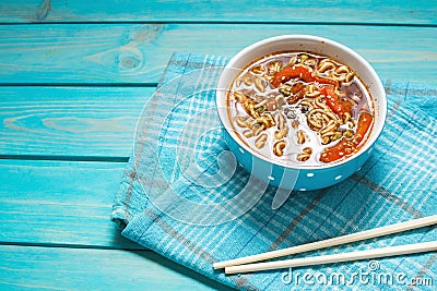 Fresh asian vegetable soup with noodles on blue wood background Stock Photo