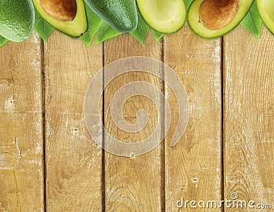 Fresh avocado with leaves on wooden background. Stock Photo