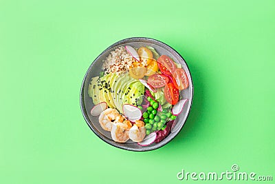 Fresh Avocado, shrimps salad with green pies, cherry tomatoes, herbs and olive oil, lemon dressing Stock Photo