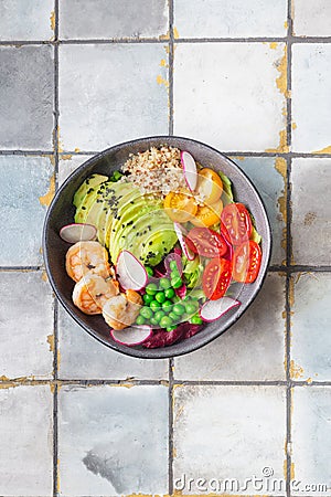 Fresh Avocado, shrimps salad with green pies, cherry tomatoes, herbs and olive oil, lemon dressing Stock Photo