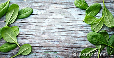 Fresh Baby spinach leaves on blue wooden background. Top view with copy space, horizontal frame. Healthy, Ecology Stock Photo