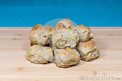 Fresh baked biscuits stacked on a wooden butcher block Stock Photo