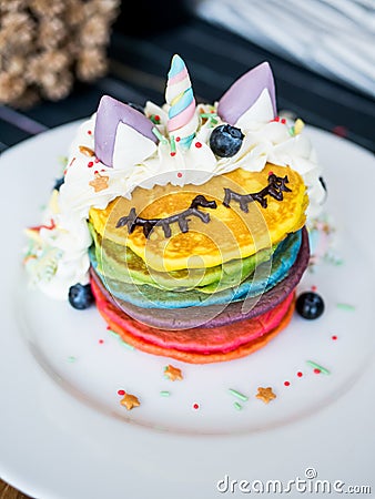 Fresh baked cute unicorn Rainbow Pancake with. kids meal. Stock Photo