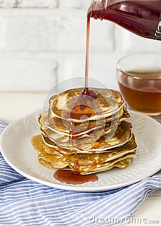 Homemade pancake poured syrup drops in white plate, closeup Stock Photo