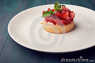 Fresh baked homemade pie with strawberries and whipped cream and cinnamon on white plate. close-up. top or overhead view Stock Photo