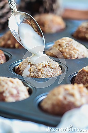 Fresh Baked Pumpkin Muffins in Baking Pan with Icing Stock Photo