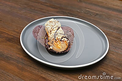 fresh baked sweet creamy eclair sweet dessert on plate kitchen wooden table, sugar food, utensils dishware, home cooking Stock Photo