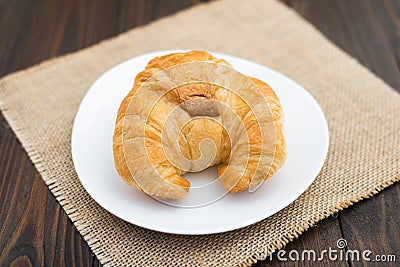 Fresh baked tasty croissants on brown napkin Stock Photo