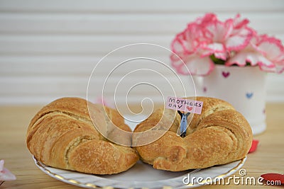 Mothers day breakfast with warm croissants and fresh flowers Stock Photo