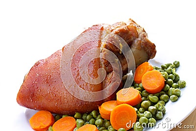 Fresh Bavarian roasted knuckle of pork with carrot Stock Photo