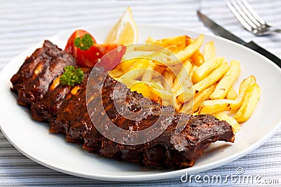 Fresh BBQ, marinated spareribs and fries Stock Photo