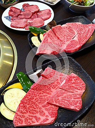 Fresh beef slice for grill serving on the tray with some vegetable, mashroom pepper pumkin eggplant and aubergine which focus-on-f Stock Photo